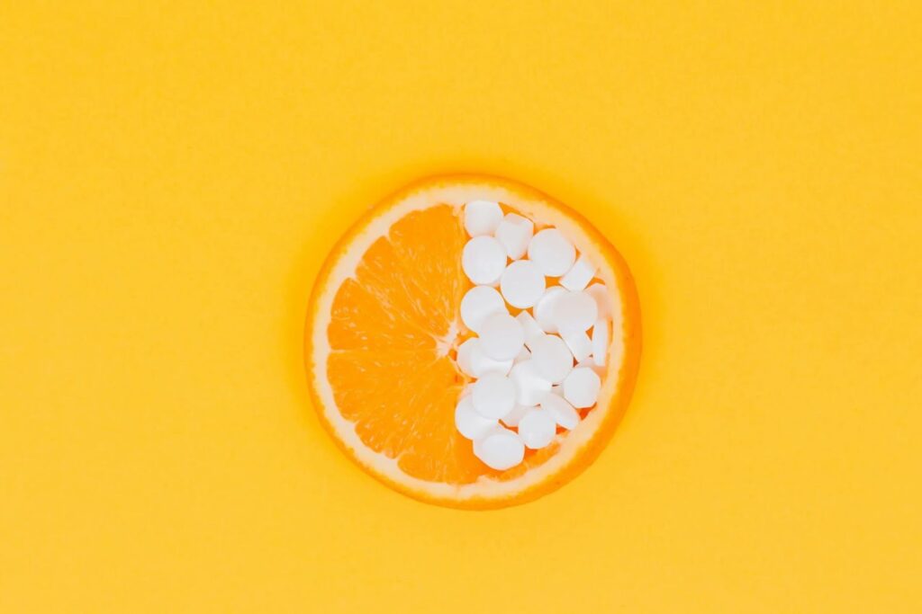 orange slice with half vitamin c supplements